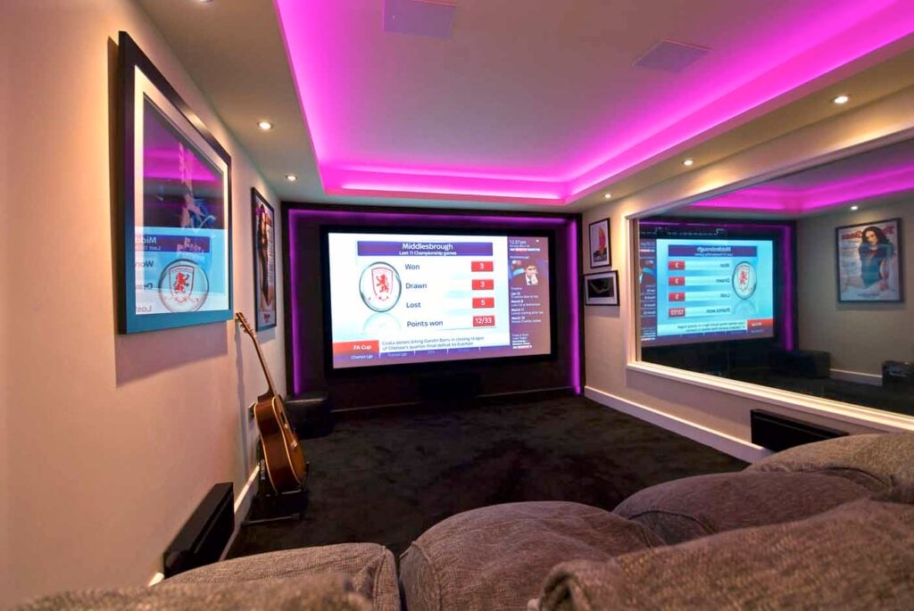 Garage converted into a home cinema with feature lighting