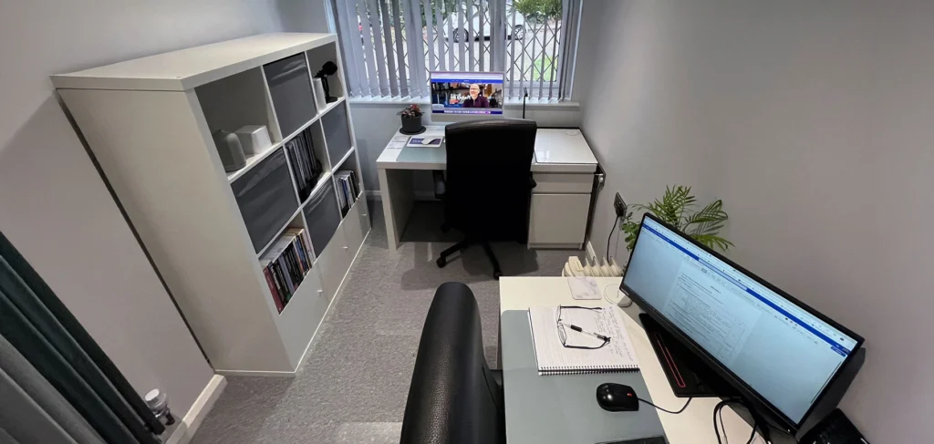 Garage converted into a home office with desk and shelving
