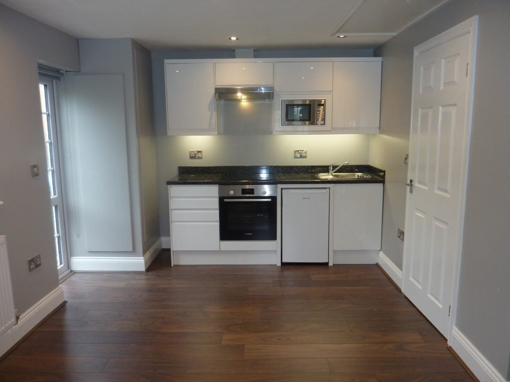 Garage converted into a modern kitchen with wood flooring