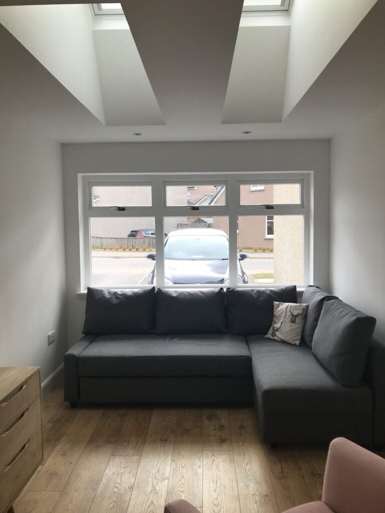 Garage converted into a bright living room with a corner sofa